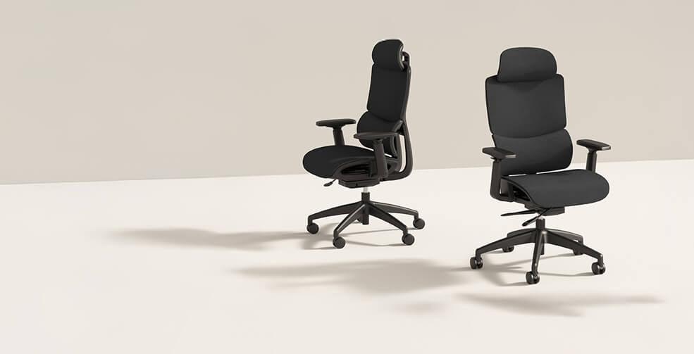 Two black office chairs on a white surface with a beige background